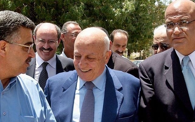 Azmi Shuaibi (left) speaks to Palestinian politicians Ahmad Qureia and Saeb Erekat in Ramallah, July 17, 2004 (photo credit: AP/Nasser Shiyoukhi)