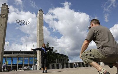 Tourists photograph themselves in front of the Berlin 1936 Olympic Stadium, its twin towers and Olympic symbol still soaring high (photo credit: AP Photo/David J. Phillip)