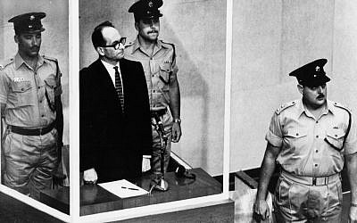 This 1961 file photo shows Adolf Eichmann standing in his glass cage in the Jerusalem courtroom where he was tried and convicted of war crimes committed during World War II. (AP Photo,b/w file)