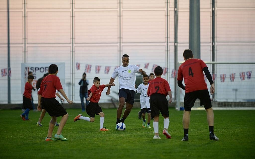Arab and Jewish children play football with Maccabi Tel Aviv stars Maharan Radi (pictured), Sheran Yeini and Maccabi Haifa's Dekel Keinan as part of a British Embassy and The Equaliser coexistence football project. Monday's tournament marked 100 years since the Christmas truce of 1914. (photo courtesy: Ben Kelmer/British Consulate) Arab and Jewish children play football with Maccabi Tel Aviv stars Maharan Radi (pictured), Sheran Yeini and Maccabi Haifa's Dekel Keinan as part of a British Embassy and The Equaliser coexistence football project. Monday's tournament marked 100 years since the Christmas truce of 1914. (photo courtesy: Ben Kelmer/British Consulate)