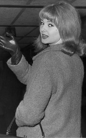 FILE - In this Jan. 7, 1964 file photo, Mandy Rice-Davies waves goodbye at London Airport as she leaves for Munich for a singing engagement. (Photo credit:AP/File)