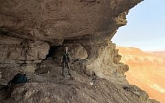 An official at the Cave of Skulls in an undated photo provided by the IAA. (photo credit: courtesy IAA)