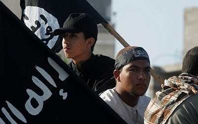 Palestinian demonstrators in Rafah, southern Gaza Strip, hold Islamic State flags as they protest an American film insulting the Prophet Muhammad, September 14, 2012. (Abed Rahim Khatib/Flash90)