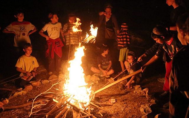 Israeli children gather around a bonfire on the Jewish holiday of Lag Ba'Omer, in Jerusalem. Lag Ba'Omer commemorates the death of Rabbi Shimon Bar Yochai, one of the most important sages in Jewish history 1,800 years ago. The most well-known custom of Lag Ba'Omer is the lighting of bonfires throughout Israel and in Jewish communities worldwide. (Photo credit: Yossi Zamir/Flash 90)