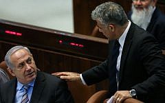 Then-finance minister Yair Lapid with Prime Minister Benjamin Netanyahu in the Knesset in 2013 (Yonatan Sindel/Flash90)