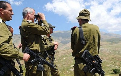 IDF Chief of Staff Benny Gantz uses binoculars as he tours the Israel-Syria border on May 21, 2013. (Tal Manor/IDF Spokesman/Flash 90)