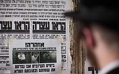 Illustrative photo of an Ultra Orthodox Jewish man reading a "Pashkvil"-- an information poster -- in the ultra-Orthodox Jerusalem neighborhood of Meah Shearim, August 19, 2014. (Photo credit: Yonatan Sindel/Flash90)