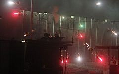 Illustrative photo of Israeli border police and soldiers clashing with Palestinians shooting fireworks at the Qalandiya checkpoint on July 24, 2014. (Issam Rimawi/FLASH90)
