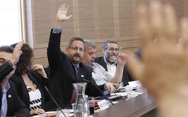 Dov Lipman of Yesh Atid votes at a Knesset Finance Committee meeting, September 2014 (Photo credit: Miriam Alster/Flash90)