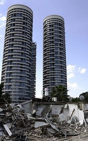 Backdropped by luxury towers, destroyed homes are seen in the Givat Amal neighborhood of Tel Aviv in September 2014. (photo credit: Tomer Neuberg/Flash90)
