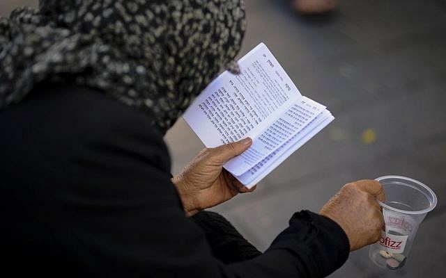 Illustrative photo of a Jewish woman seen with a prayer book (Photo credit: Mendy Hechtman/FLASH90)