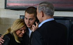 Prime Minister Benjamin Netanyahu and his wife Sara, seen with their son Avner (C) as he prepares to begin his IDF service, December 01, 2014. (photo credit: Kobi Gideon/GPO)