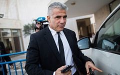 Finance Minister Yair Lapid leaves a financial conference in Jerusalem on December 2, 2014 (photo credit: Yonatan Sindel/Flash90)