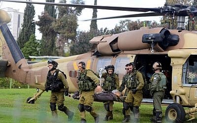 An IDF soldier wounded in a cross-border attack outside Gaza is carried into Soroka Hospital in the southern city of Beersheba on December 24, 2014 (photo credit: Flash90)