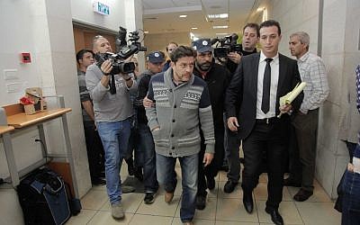 Yisrael Beytenu chief of staff David Godowsky is brought to the Rishon Lezion Magistrate's Court on December 24, 2014. (photo credit: FLASH90)