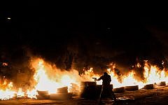 Illustrative: Givat Amal residents burn tires on December 29, 2014. (Amir Levi/Flash90)