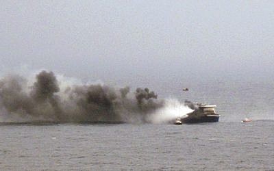 In this image provided by the Italian Navy, smoke billows from the Italian-flagged Norman Atlantic after it caught fire in the Adriatic Sea, Sunday, Dec. 28, 2014. (Photo credit: AP/Italian Navy)