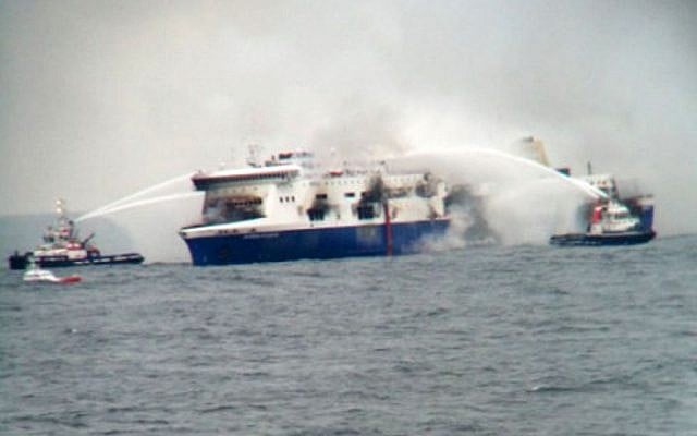 In this photo taken from a nearby ship, vessels try to extinguish the fire at the Italian-flagged Norman Atlantic after it caught fire in the Adriatic Sea, Sunday, Dec. 28, 2014. (photo credit: AP Photo/SKAI TV Station) 