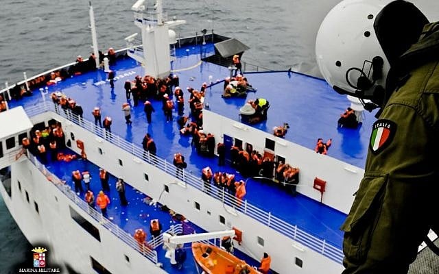 In this image released by the Italian Navy, passengers and crew are seen on the deck of the Italian-flagged ferry Norman Atlantic as it is approached by a rescue helicopter after it caught fire in the Adriatic Sea, Sunday, Dec. 28, 2014. (photo credit: AP/Italian Navy) In this image released by the Italian Navy, passengers and crew are seen on the deck of the Italian-flagged ferry Norman Atlantic as it is approached by a rescue helicopter after it caught fire in the Adriatic Sea, Sunday, Dec. 28, 2014. (photo credit: AP/Italian Navy)