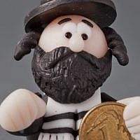 A Lucky Jew figurine holding a coin, 2013, maker unknown (photo credit: Grzegorz Mart)