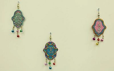 Three controversial 'hamsa' talismans produced by artist Gal Volinez, December 2014. (photo credit: Sapir College/Liron Buzaglo)