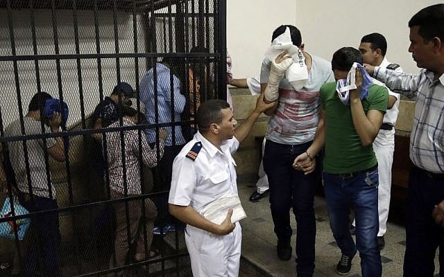 Eight Egyptian men convicted for 'inciting debauchery' following their appearance in a video of an alleged same-sex wedding party on a Nile boat leave the defendant's cage in a courtroom in Cairo, Egypt,  November 1, 2014. (photo credit: AP/Hassan Ammar, File)
