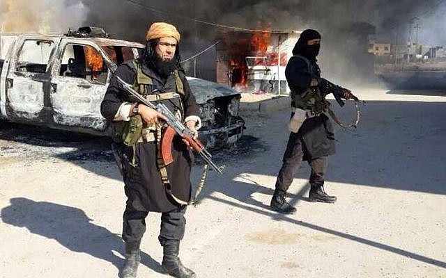 This undated file image posted on a militant website on January 4, 2014, which is consistent with other AP reporting, shows Shakir Waheib, a senior member of the Islamic State of Iraq and the Levant (ISIL), now called the Islamic State group, left, next to a burning police vehicle in Iraq's Anbar Province. (Photo credit: AP via militant website, File) This undated file image posted on a militant website on January 4, 2014, which is consistent with other AP reporting, shows Shakir Waheib, a senior member of the Islamic State of Iraq and the Levant (ISIL), now called the Islamic State group, left, next to a burning police vehicle in Iraq's Anbar Province. (Photo credit: AP via militant website, File)