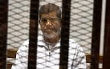 In this May 8, 2014 file photo, Egypt's ousted Islamist President Mohammed Morsi sits in a defendant cage in the Police Academy courthouse in Cairo, Egypt. (AP/Tarek el-Gabbas, File)