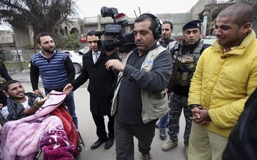 In this photo taken Tuesday, Dec. 16, 2014, Haider Ali Motar, right, performs a scene from "In the Grip of the Law," a reality show produced by Iraqi state TV. Motar was convicted about a month ago for helping to carry out a string of Baghdad car bombings on behalf of the Islamic State extremist group. (AP Photo/Hadi Mizban) In this photo taken Tuesday, Dec. 16, 2014, Haider Ali Motar, right, performs a scene from "In the Grip of the Law," a reality show produced by Iraqi state TV. Motar was convicted about a month ago for helping to carry out a string of Baghdad car bombings on behalf of the Islamic State extremist group. (AP Photo/Hadi Mizban)