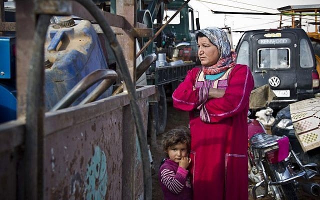 A Kurdish woman looks on at the mortars exploding close by in Kobani, Syria on November 22, 2014. (photo credit: AP Photo/Jake Simkin) A Kurdish woman looks on at the mortars exploding close by in Kobani, Syria on November 22, 2014. (photo credit: AP Photo/Jake Simkin)