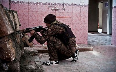 A Kurdish fighter takes position in Kobani, Syria, November 1, 2014. (photo credit: AP/Jake Simkin)