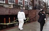 A crime scene investigator, center, passes a member of the Lubavitch community as he enters Chabad-Lubavitch Hasidic headquarters, Tuesday, Dec. 9, 2014, in New York. Earlier a knife-wielding man stabbed an Israeli student inside the Brooklyn synagogue before being fatally shot by police after he refused to drop the knife. The student, Levi Rosenblatt, is in stable condition. (Photo credit: Mark Lennihan/AP)