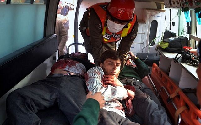 Pakistani rescue workers remove students from an ambulance after they were injured in a shootout at a school under attack by Taliban gunmen, in Peshawar, Pakistan, Tuesday, Dec. 16, 2014. (photo credit: AP/Mohammad Sajjad)