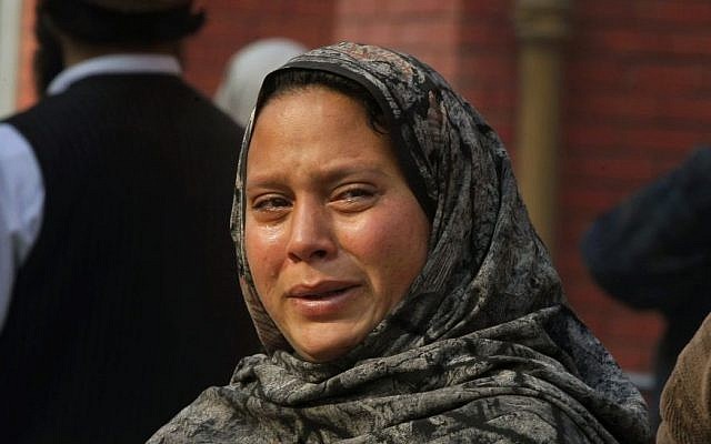 A Pakistani woman weeps as she waits at a hospital, where victims of a Taliban attack on a school were being treated in Peshawar, Pakistan,Tuesday, Dec. 16, 2014. (photo credit: AP/Mohammad Sajjad)