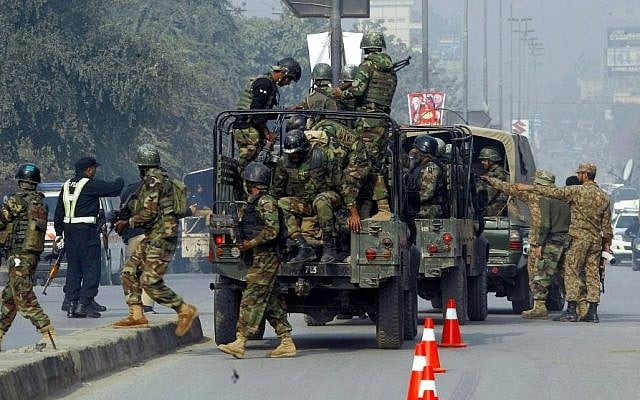 Pakistani army troops arrive to conduct an operation at a school under attack by Taliban gunmen in Peshawar, Pakistan, Dec. 16, 2014. (photo credit: AP/Mohammad Sajjad)