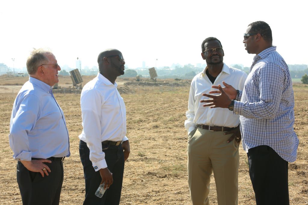 Pastor on a Christians United for Israel solidarity mission stand near an Iron Dome cell during this summer's Operation Protective Edge. (courtesy)