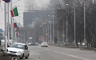 Smoke rises from a publishing house in the center of Grozny, Russia, early Thursday, Dec. 4, 2014. (photo credit: AP/Musa Sadulayev)