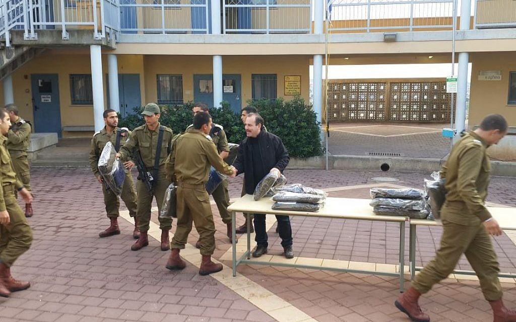 Yashar Lachayal's Leon Blankrot, in black, handing out aid packages with cold-weather gear to an all-Druze Israeli army unit, Nov. 28, 2014. (Courtesy Yashar Lachayal/JTA) Yashar Lachayal's Leon Blankrot, in black, handing out aid packages with cold-weather gear to an all-Druze Israeli army unit, Nov. 28, 2014. (Courtesy Yashar Lachayal/JTA)