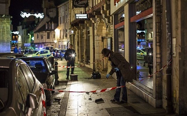 A policewoman collects evidence on December 21, 2014 in Dijon on the site where a driver shouting "Allahu Akbar" ("God is great") ploughed into a crowd injuring 11 people, two seriously, a source close to the investigation said. (photo credit: AFP PHOTO / ARNAUD FINISTRE) A policewoman collects evidence on December 21, 2014 in Dijon on the site where a driver shouting "Allahu Akbar" ("God is great") ploughed into a crowd injuring 11 people, two seriously, a source close to the investigation said. (photo credit: AFP PHOTO / ARNAUD FINISTRE)