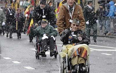 US WWII veteran Bob Izumy of the 101st AB 506, participates in a parade during the 70th anniversary of the WWII Battle of the Bulge or the Ardennes Offensive, in Bastogne, Southeastern Belgium, Saturday, Dec. 13, 2014. (photo credit: AP Photo/Yves Logghe)