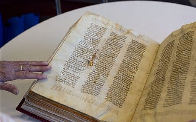 In this October 5, 2014, photo, a library official shows a Jewish manuscript smuggled into Israel from Damascus in a Mossad spy operation in the early 1990s, in Jerusalem. (photo credit: AP/Sebastian Scheiner, File) In this October 5, 2014, photo, a library official shows a Jewish manuscript smuggled into Israel from Damascus in a Mossad spy operation in the early 1990s, in Jerusalem. (photo credit: AP/Sebastian Scheiner, File)