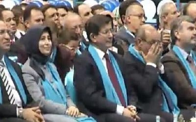 Turkish Prime Minister Ahmet Davutoglu listens to a speech by Hamas leader Khaled Mashaal in the Turkish city of Konya on Saturday, December 27, 2014. Photo credit: Screenshot/YouTube)
