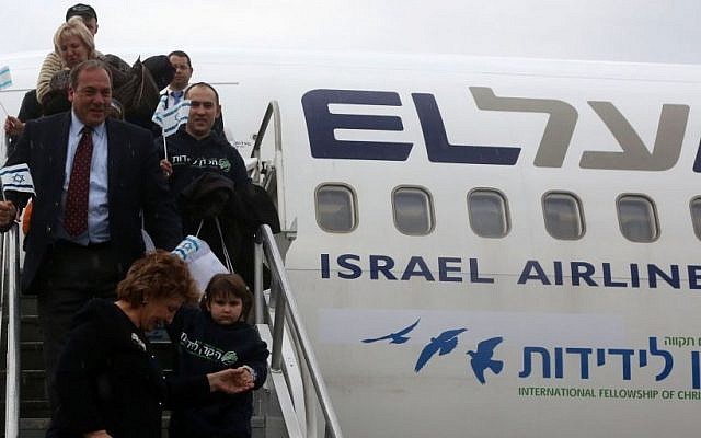 Rabbi Yechiel Eckstein with some of the 224 Ukrainian Jewish refugees arrive in Israel on his organizations's first "Fellowship Aliya" flight, December 22, 2014. (photo credit: International Fellowship of Christians and Jews)