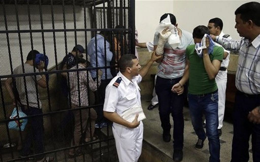 Illustrative: Eight Egyptian men convicted for 'inciting debauchery,' following their appearance in a video of an alleged same-sex wedding party on a Nile boat leave the defendant's cage in a courtroom in Cairo, Egypt, November 1, 2014. (AP/Hassan Ammar, File) Illustrative: Eight Egyptian men convicted for 'inciting debauchery,' following their appearance in a video of an alleged same-sex wedding party on a Nile boat leave the defendant's cage in a courtroom in Cairo, Egypt, November 1, 2014. (AP/Hassan Ammar, File)