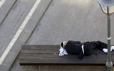 Illustrative photo of a man sleeping on a bench in the center of Jerusalem November 9, 2014. (Photo credit: Nati Shohat/FLASH90)