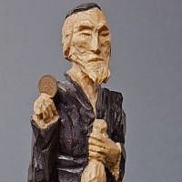 A Lucky Jew figurine holding a coin, maker unknown (photo credit: Grzegorz Mart)