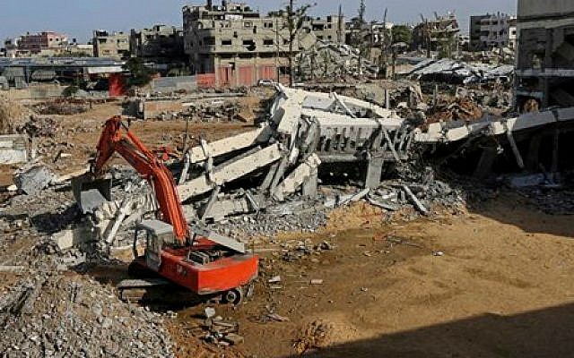 A Palestinian crane removes the rubble of the Jamal Abdelnaser UNRWA School in Shejaiya, a neighborhood in Gaza City, in the northern Gaza Strip, December 3, 2014. (AP/Adel Hana) A Palestinian crane removes the rubble of the Jamal Abdelnaser UNRWA School in Shejaiya, a neighborhood in Gaza City, in the northern Gaza Strip, December 3, 2014. (AP/Adel Hana)