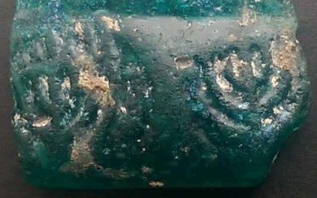 A 1,600-year-old glass shard imprinted with two menorahs, one fully lit (Courtesy: Israel Antiquities Authority) A 1,600-year-old glass shard imprinted with two menorahs, one fully lit (Courtesy: Israel Antiquities Authority)