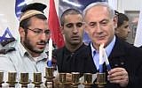 Prime Minister Benjamin Netanyahu lights the first candle of Hanukkah, December 16, 2014. (Screenshot: YouTube/GPO)