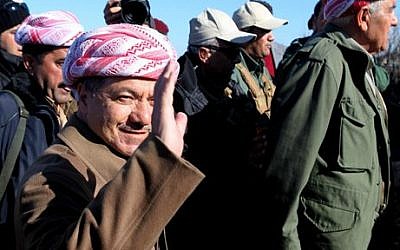 Kurdistan Iraqi regional government President Massoud Barzani arrives to support Kurdish forces as they head to battle Islamic State fighters, on the summit of Mount Sinjar, in the town of Sinjar, Iraq, Sunday, Dec. 21, 2014 (photo credit: AP/Zana Ahmed) 
